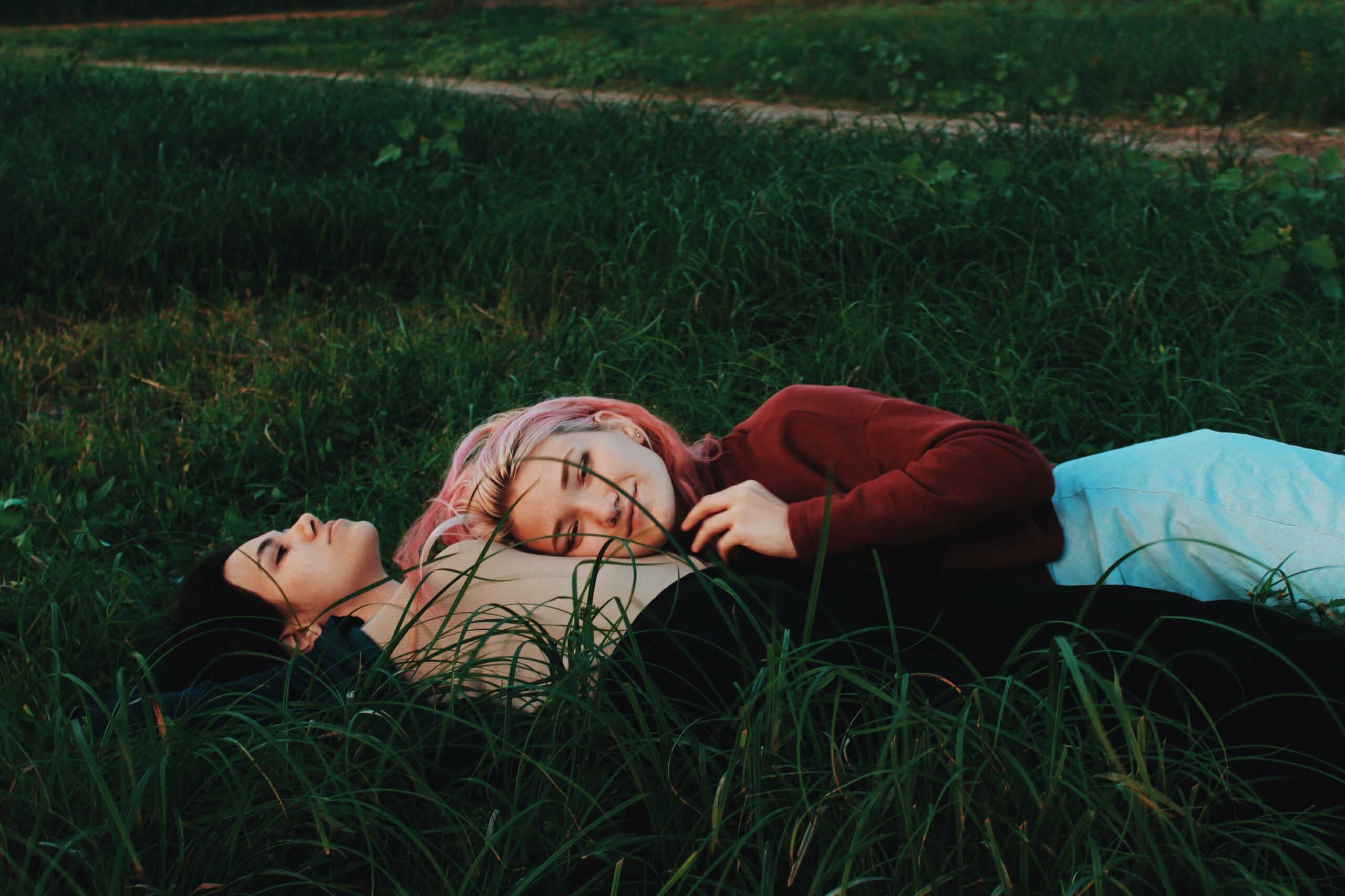 Photo by Masha S of couple cuddling in grass